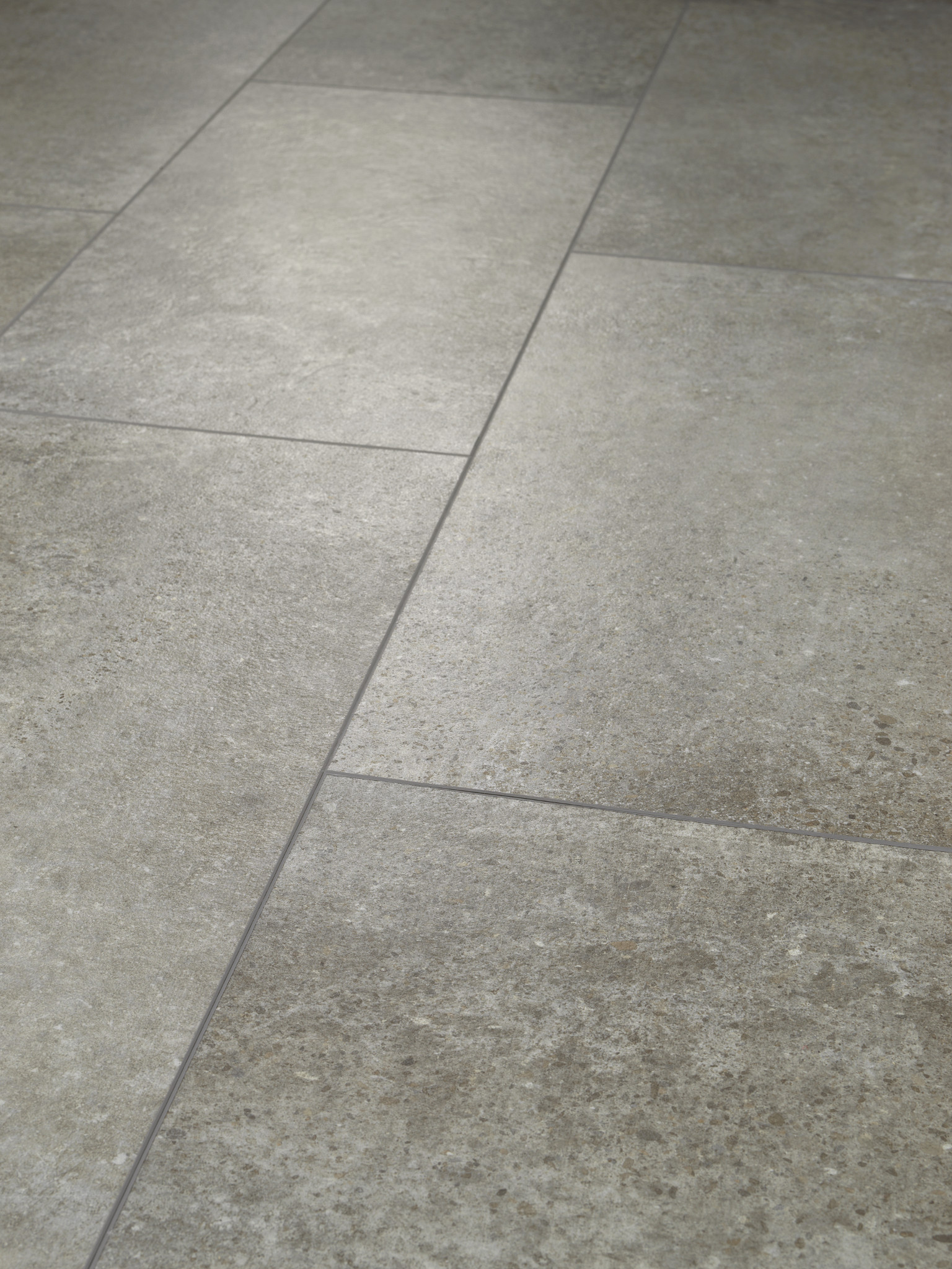 Close-up view of durable gray tile floor with a textured stone-like finish
